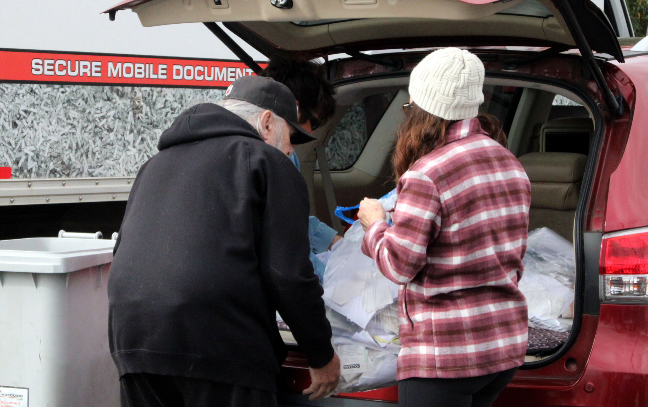 Lines of Cars Stretch Across Lot for Shredding Services